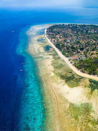 Aerial view of a coral reef wall surrounding a small tropical island (Gili Air, Indonesia)の写真素材