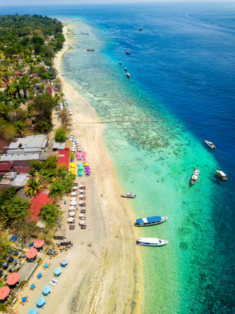 Aerial view of a tropical beach resort next to a coral reef on a small island (Gili Air, Indonesia)の写真素材