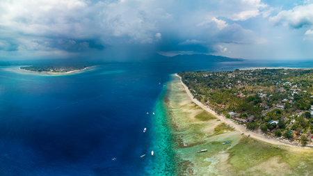 Aerial view of a tropical island, coral reef and stormy skyの写真素材