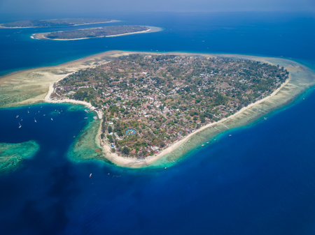 Aerial view of the harbor, port and boats of the tiny tourist island of Gili Air off the island of Lombokの写真素材