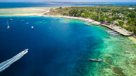 Boats surrounding a coral reef and small tropical islandの写真素材