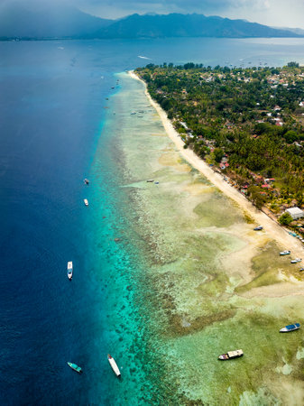 Traditional outrigger boats on the tropical coral reef at Gili Air near Lombok, Indonesiaの写真素材