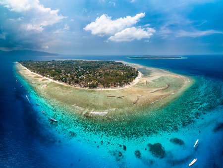 Aerial view of fringing coral reef surrounding a small tropical island in a warm ocean (Gili Air, Indonesia)の写真素材