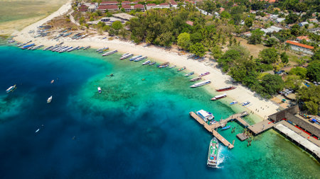 Tourist boats and ferries at the port on the small tropical island of Gili Air in Lombok, Indonesiaの写真素材