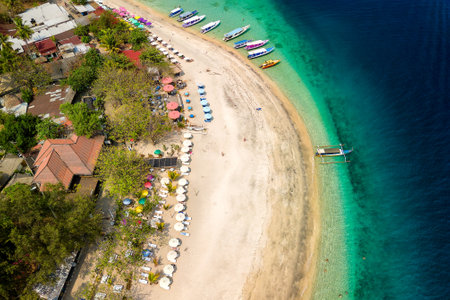 Aerial view of small tourist resorts and sunshades on a tropical island (Gili Air, Lombok, Indonesia)の写真素材