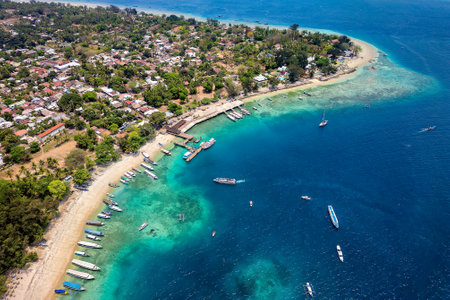 Aerial view of a port and coral reef on the coast of a small tropical island in Indonesia (Gili Islands, Lombok)の写真素材