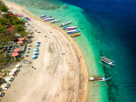 Aerial view of colorful sunshades on a tropical beach (Gili Air, Indonesia)の写真素材
