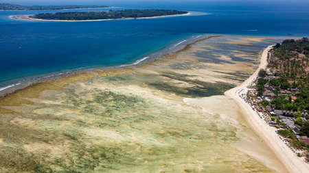 Aerial view of a large reef flat (table) of a fringing coral reef in Indonesiaの写真素材