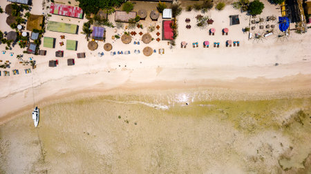 Aerial view of colorful sunshades on a tropical beach (Gili Air, Indonesia)の写真素材