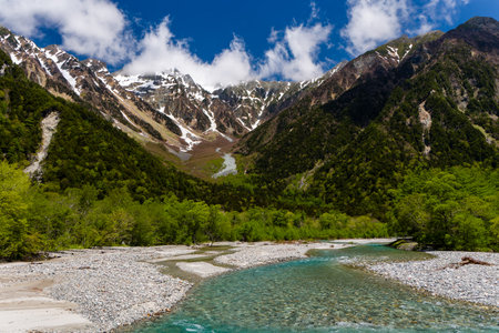 Clear, cold river running through a forested valley. River Azusa, Kamikochi, Japanの写真素材
