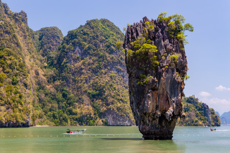 PHANG NGA, THAILAND - MARCH 31 2023: Tourist boats exploring the ocean and limestone formations of Ko Tapu (James Bond Island) in Phang Nga Bayのeditorial素材