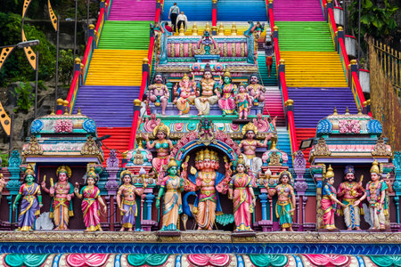 KUALA LUMPUR, MALAYSIA - APRIL 12 2024: Colorful carvings and sculptures at the entrance to the Batu...