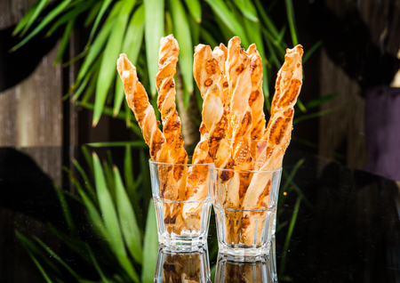 Crispy bread sticks on old wooden table.
