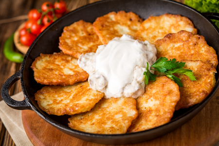 Fried savory pancakes with potato, onion and garlicの写真素材