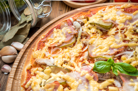 delicious italia pizza in a restaurant, on the wooden deskの写真素材