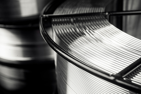 welding wire, stainless steel, on a black backgroundの写真素材