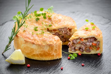 Tasty pie with different fillings on the tableの写真素材