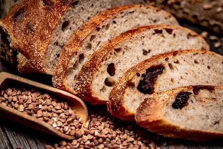 Freshly baked traditional bread on wooden table.の写真素材