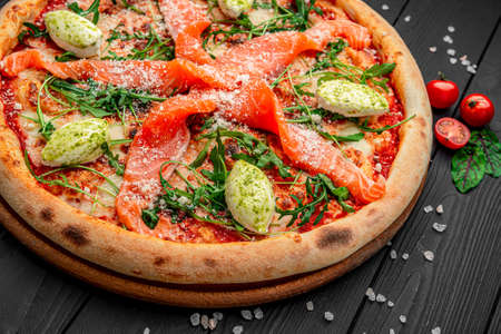 Pizza with salmon and cream cheese. health food. Serving food in a restaurantの写真素材