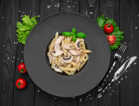 Penne pasta with mushrooms and chicken. health food. Serving food in a restaurantの写真素材