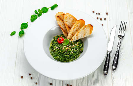 Mussels in a creamy spinach sauce in a pan. Serving food in a restaurant. Photo for the menuの写真素材