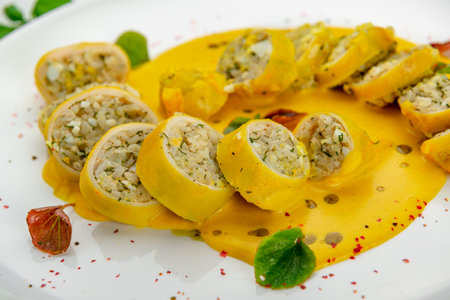 Stuffed squid with rice and vegetables with cheese sauce. Serving food in a restaurant. Photo for the menuの写真素材