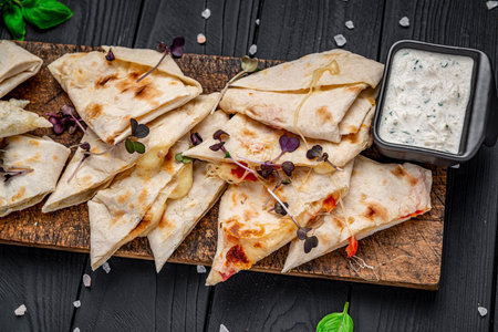 Fried pita bread with cheese and tomatoes. Serving food at the bar