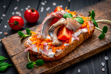 Herring fillet. Scandinavian cuisine. Sandwich with slices of pickled Atlantic herring fillet, pickled onions and carrotsの写真素材