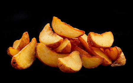 Pile of french fries over black background. Photo for the menuの写真素材