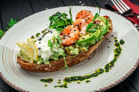 Bruschetta with shrimp, guacamole, cream cheese and pesto sauce. Healthy and wholesome food. Serving food in a restaurant. Photo for the menu.の写真素材