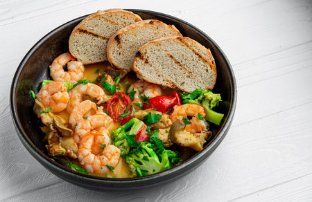 Shrimps in a creamy sauce with mushrooms, broccoli and various vegetables. Health food.の写真素材