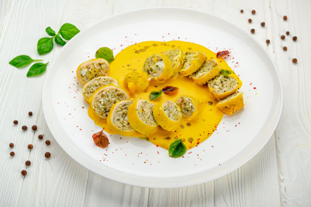 Stuffed squid with rice and vegetables with cheese sauce. Serving food in a restaurant. Photo for the menuの写真素材