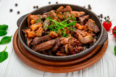 Meat and vegetables in frying pan. Serving food in a restaurantの写真素材