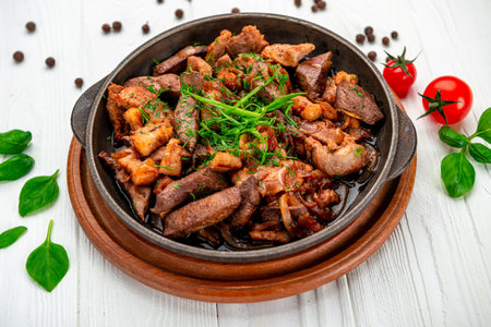 Meat and vegetables in frying pan. Serving food in a restaurantの写真素材