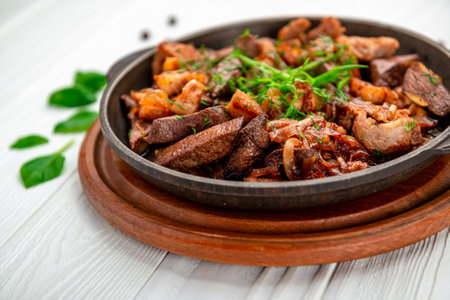 Meat and vegetables in frying pan. Serving food in a restaurantの写真素材