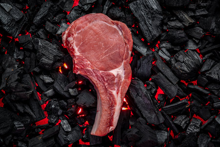 Raw steak on hot barbecue coals. organic meatの写真素材