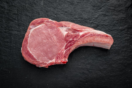 Fresh, raw pork steak on a dark background. fresh meatの写真素材