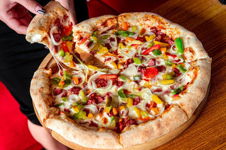 Tasty and big pizza with different types of meat. Top view of hot pizza.の写真素材