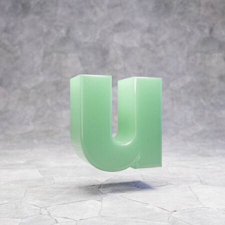Jade letter U lowercase on rocky backgrond. 3D rendered jade gemstone font. Best for jewelry advertising, anniversary, celebration.の写真素材