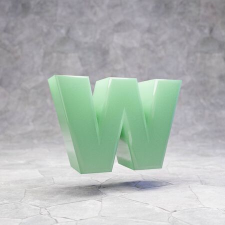 Jade letter W lowercase on rocky backgrond. 3D rendered jade gemstone font. Best for jewelry advertising, anniversary, celebration.の写真素材