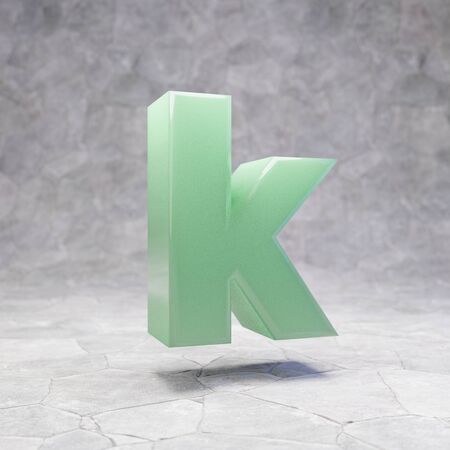 Jade letter K lowercase on rocky backgrond. 3D rendered jade gemstone font. Best for jewelry advertising, anniversary, celebration.の写真素材