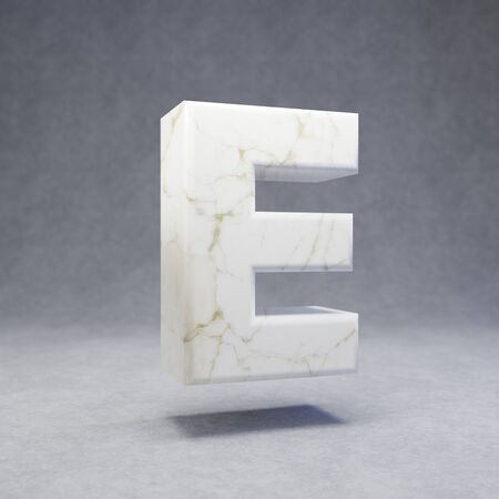 White marble letter E uppercase on concrete background. 3d rendered glossy stone font character.の写真素材