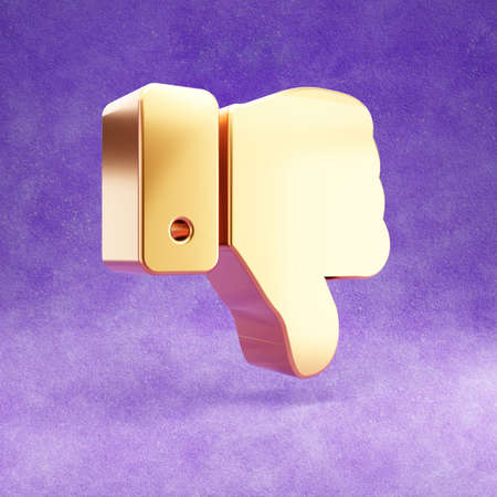 Thumbs down icon. Gold glossy Thumbs down symbol isolated on violet velvet background.の写真素材