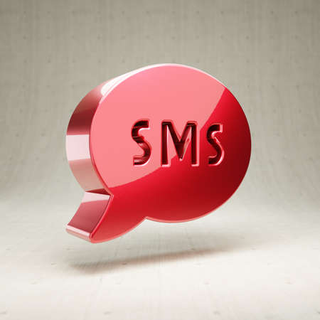 SMS icon. Red glossy metallic SMS symbol isolated on white concrete background.の写真素材