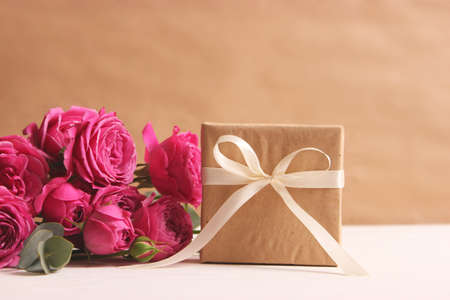 gift and flowers on a colored background. Holiday, give a gift, congratulations.の写真素材