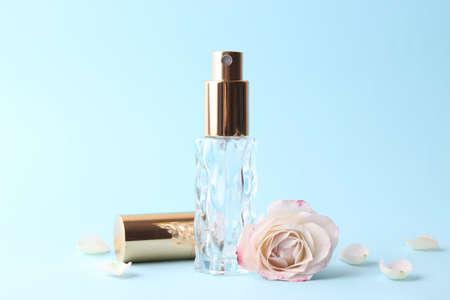 Perfume bottle and rose flowers on a light background close upの写真素材