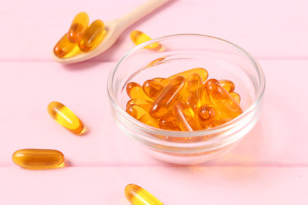 Omega-3 capsules on a colored background. Fish oil, healthy supplementsの写真素材