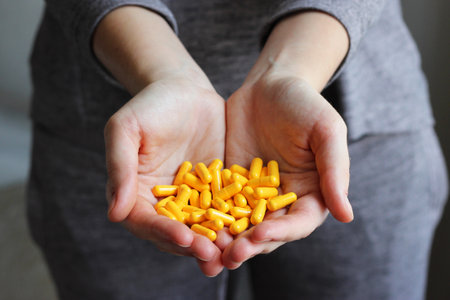 Medical pills in female hands. Take pills. Vitamins, food additives.