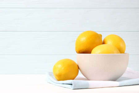 lemons and green leaves on a colored background.の写真素材