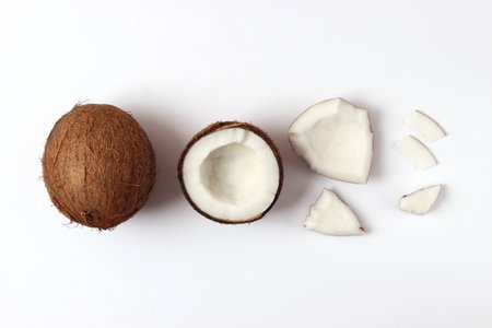 broken coconut on a white background top view.の写真素材